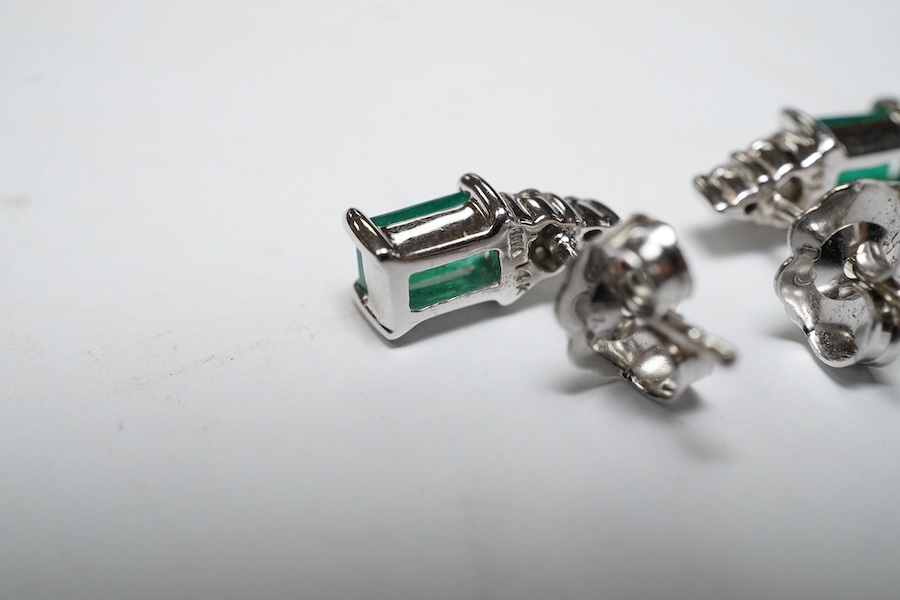 A small modern pair of 14k white metal, emerald and diamond cluster set ear studs, 9mm, gross weight 1.4 grams. Condition - good